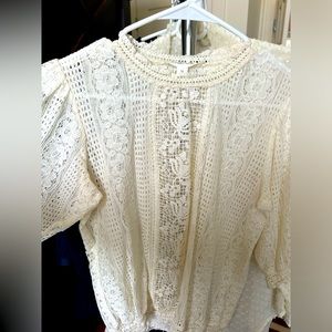 Beautiful lace style top with pop shoulder.